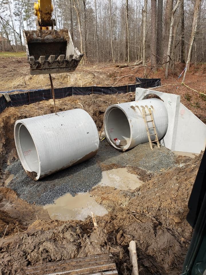An excavator connecting two sewer pipe
